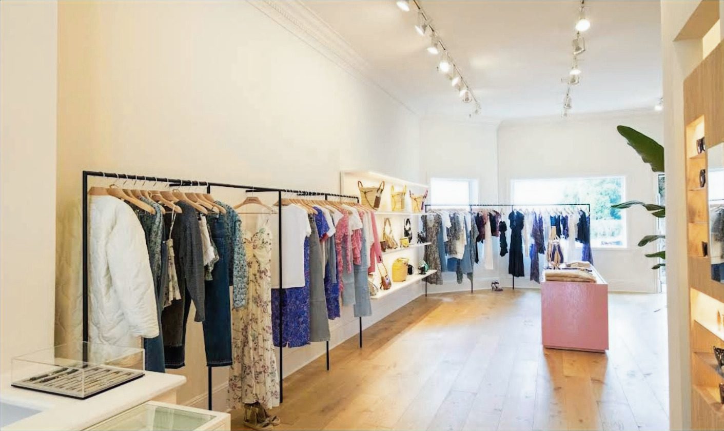 Main sales floor: white lacquer walls, natural oak floors, b